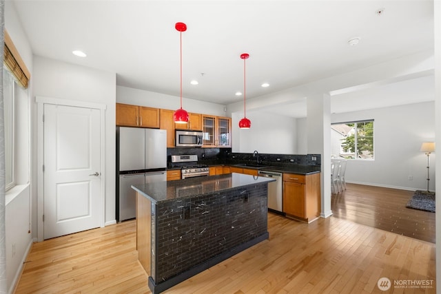 21270 40th Way S Unit 35, Seatac, WA 98198 - kitchen with appliances with stainless steel finishes, light wood-style floors, backsplash, glass insert cabinets, and recessed lighting