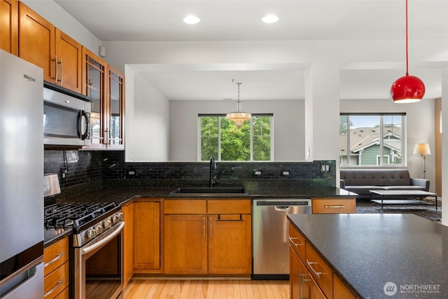21270 40th Way S Unit 35, Seatac, WA 98198 - kitchen with stainless steel appliances, brown cabinetry, light wood finished floors, decorative backsplash, and recessed lighting