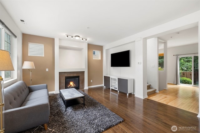 21270 40th Way S Unit 35, Seatac, WA 98198 - living area with hardwood / wood-style floors, a tiled fireplace, and stairs