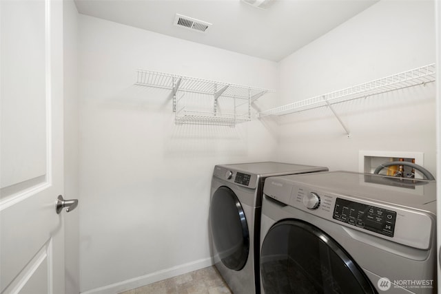 21270 40th Way S Unit 35, Seatac, WA 98198 - washroom with washer and dryer and baseboards