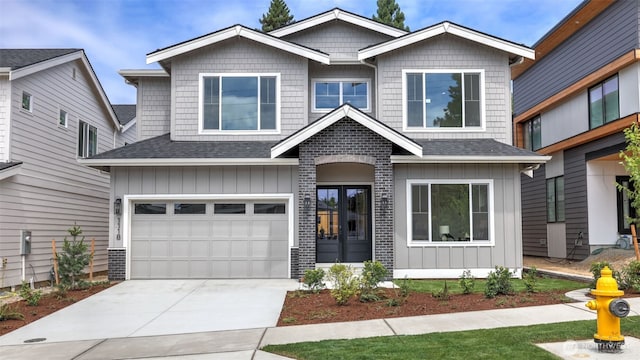 1118 N 34th St, Renton, WA 98056 - view of front of house with concrete driveway, roof with shingles, an attached garage, and board and batten siding