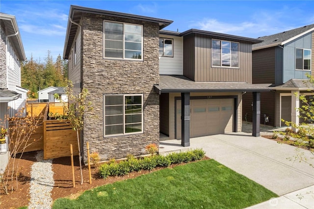 20851 156th St E, Bonney Lake, WA 98391 - view of front of house featuring stone siding, driveway, and a garage
