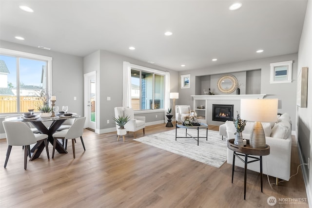 20851 156th St E, Bonney Lake, WA 98391 - living area featuring light wood-style floors, recessed lighting, and a glass covered fireplace