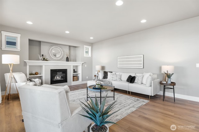 20851 156th St E, Bonney Lake, WA 98391 - living area featuring wood finished floors, recessed lighting, and a glass covered fireplace