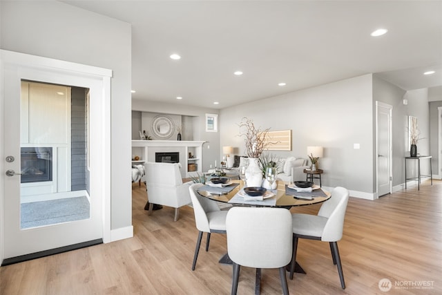 20851 156th St E, Bonney Lake, WA 98391 - dining space with a glass covered fireplace, light wood-style floors, and recessed lighting