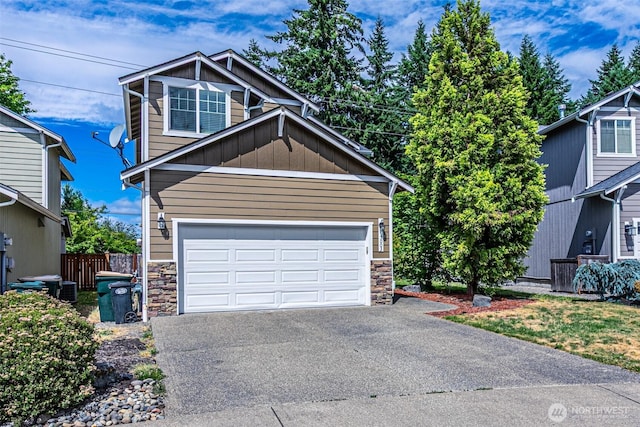 5003 Madison Heights Ct SE, Olympia, WA 98501 - view of front of house featuring stone siding, asphalt driveway, a garage, and board and batten siding