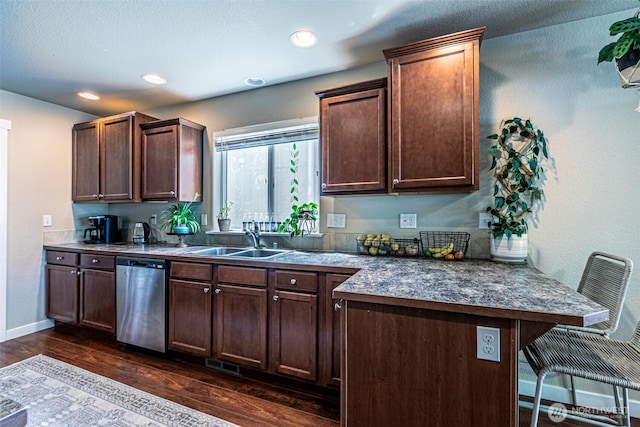 5003 Madison Heights Ct SE, Olympia, WA 98501 - kitchen with stainless steel dishwasher, a breakfast bar area, dark wood-style flooring, a peninsula, and dark countertops