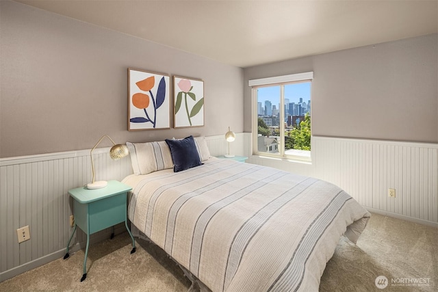 1234 Taylor Ave N Unit 401, Seattle, WA 98109 - bedroom featuring carpet, a view of skyline, and a wainscoted wall