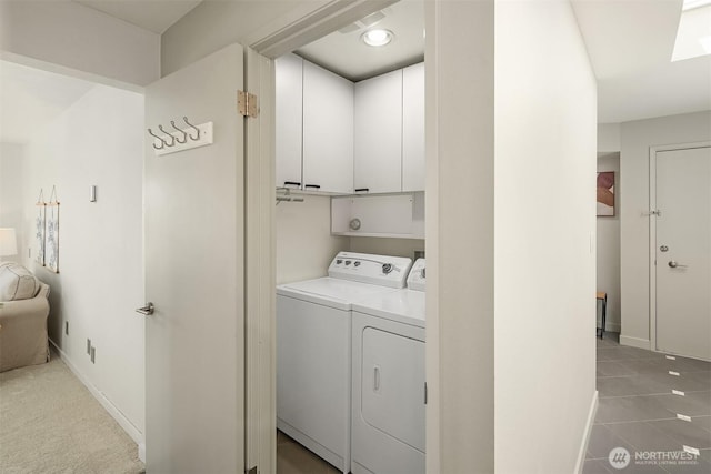1234 Taylor Ave N Unit 401, Seattle, WA 98109 - laundry area with cabinet space, washing machine and dryer, and tile patterned flooring