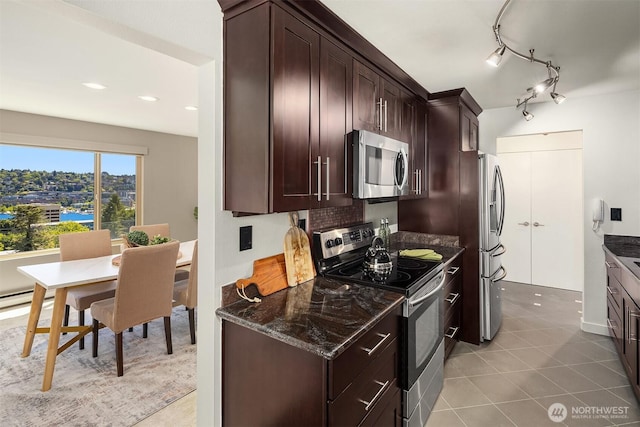 1234 Taylor Ave N Unit 401, Seattle, WA 98109 - kitchen featuring stainless steel appliances, dark brown cabinetry, dark stone counters, light tile patterned floors, and recessed lighting