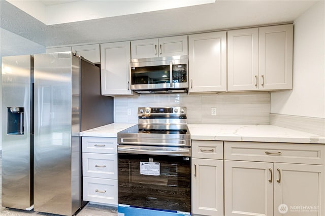 60 Crystal Ct, Sequim, WA 98382 - kitchen featuring stainless steel appliances, light stone counters, tasteful backsplash, and white cabinetry