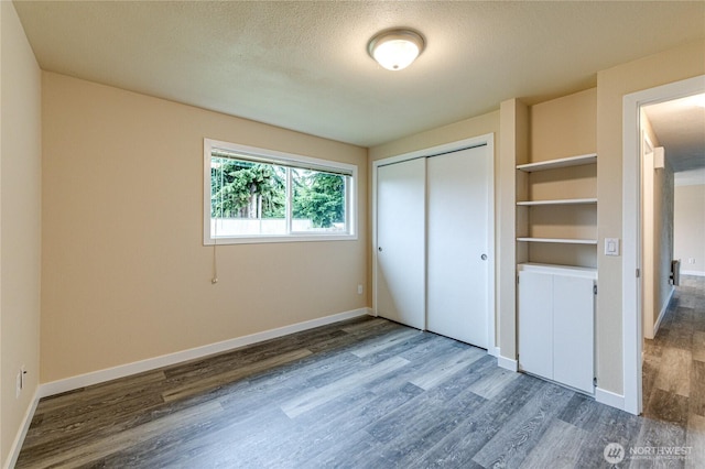 60 Crystal Ct, Sequim, WA 98382 - unfurnished bedroom with wood finished floors, a closet, and a textured ceiling