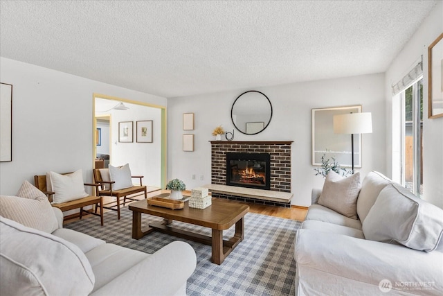 527 N 155th St, Shoreline, WA 98133 - living room featuring wood finished floors, a textured ceiling, and a fireplace