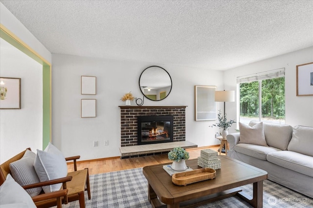 527 N 155th St, Shoreline, WA 98133 - living area with wood finished floors, a textured ceiling, and a fireplace