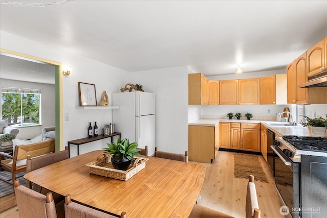 527 N 155th St, Shoreline, WA 98133 - kitchen with freestanding refrigerator, stainless steel gas range, light wood finished floors, and light brown cabinetry
