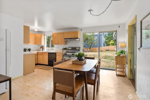 527 N 155th St, Shoreline, WA 98133 - kitchen with stainless steel gas range, dishwasher, light brown cabinetry, under cabinet range hood, and light wood finished floors