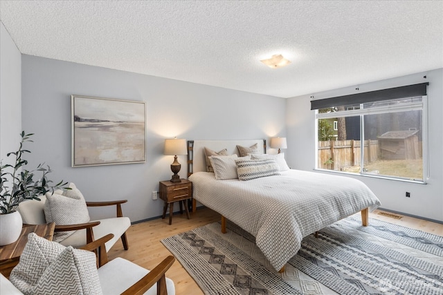 527 N 155th St, Shoreline, WA 98133 - bedroom featuring light wood finished floors and a textured ceiling