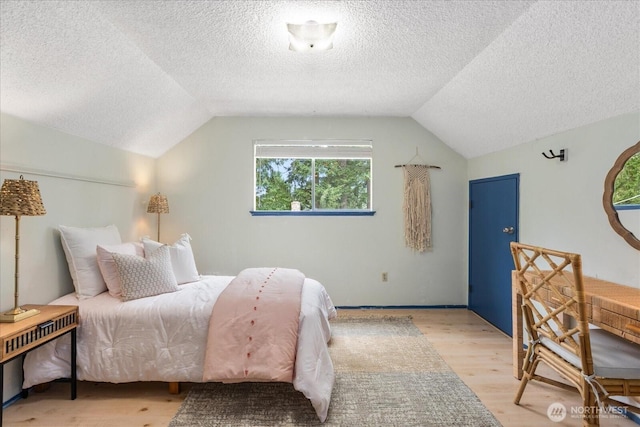 527 N 155th St, Shoreline, WA 98133 - bedroom featuring light wood finished floors, vaulted ceiling, and a textured ceiling