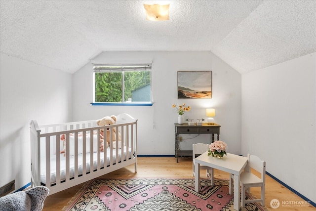 527 N 155th St, Shoreline, WA 98133 - bedroom with a textured ceiling, lofted ceiling, and wood finished floors