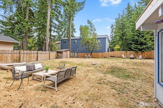527 N 155th St, Shoreline, WA 98133 - fenced backyard featuring an outdoor hangout area and a storage unit