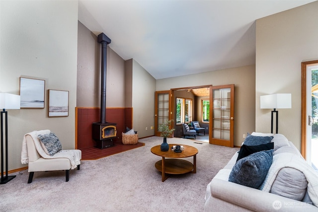 2327 31st Ave NW, Olympia, WA 98502 - living area with a wood stove, carpet floors, french doors, and lofted ceiling