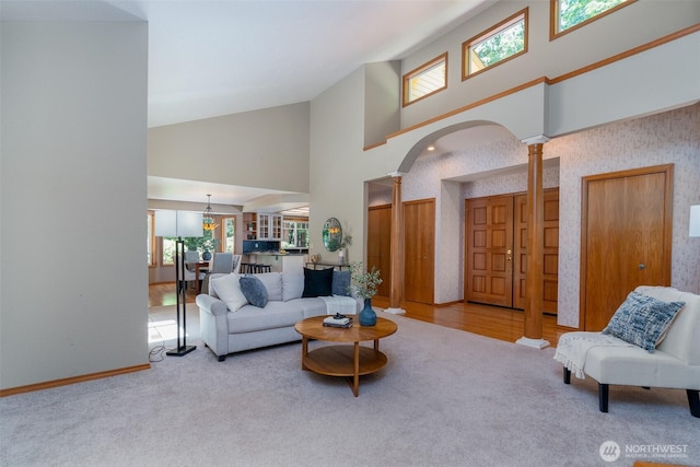 2327 31st Ave NW, Olympia, WA 98502 - living area with ornate columns, high vaulted ceiling, carpet floors, and arched walkways