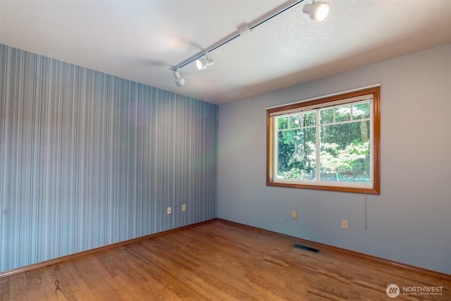 2327 31st Ave NW, Olympia, WA 98502 - unfurnished room featuring rail lighting and wood finished floors