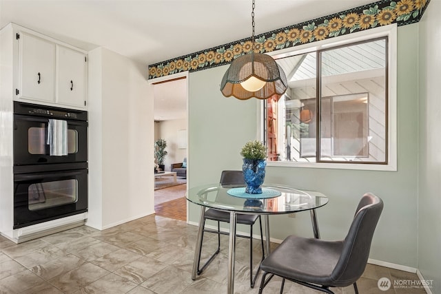 5415 Johnson Point Rd NE, Olympia, WA 98516 - dining area featuring baseboards and light marble finish floors