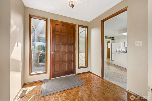 5415 Johnson Point Rd NE, Olympia, WA 98516 - entryway with baseboards and a textured ceiling