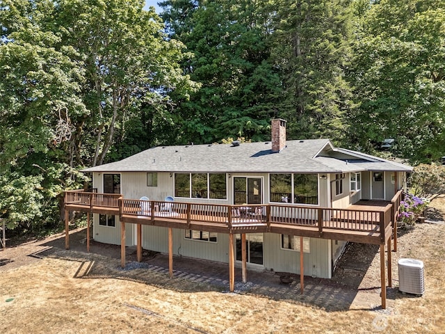 5415 Johnson Point Rd NE, Olympia, WA 98516 - rear view of property with a chimney, roof with shingles, and a wooden deck