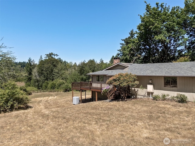 5415 Johnson Point Rd NE, Olympia, WA 98516 - rear view of house with a wooden deck, a lawn, a chimney, and stairway