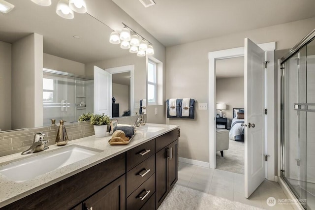 28003 74th Ave NW Unit 33, Stanwood, WA 98292 - ensuite bathroom featuring double vanity, a shower stall, plenty of natural light, and tasteful backsplash