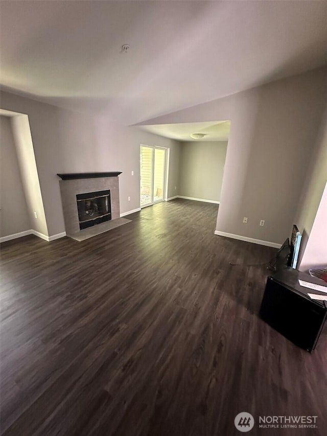 11002 SE Petrovitsky Rd Unit F302, Renton, WA 98055 - unfurnished living room with a tiled fireplace and dark wood-type flooring