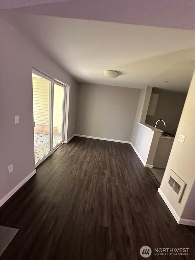 11002 SE Petrovitsky Rd Unit F302, Renton, WA 98055 - unfurnished living room featuring baseboards and dark wood finished floors