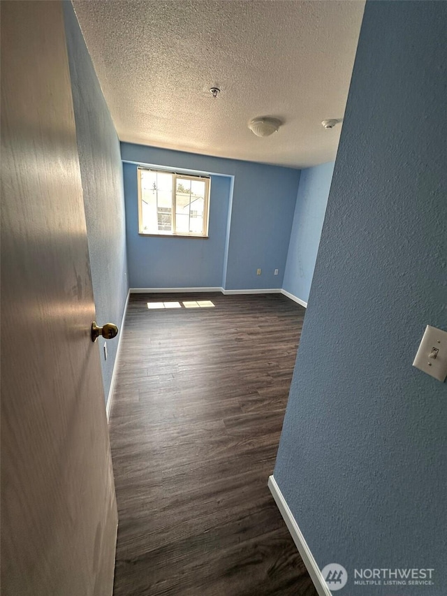 11002 SE Petrovitsky Rd Unit F302, Renton, WA 98055 - unfurnished room with a textured ceiling, wood finished floors, a textured wall, and a pendent fire sprinkler