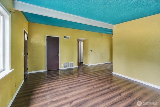 11846 SE 170th Pl, Renton, WA 98258 - spare room featuring beamed ceiling, wood finished floors, and a textured ceiling