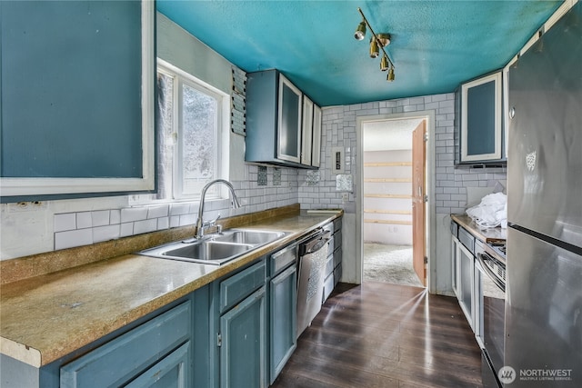 11846 SE 170th Pl, Renton, WA 98258 - kitchen with stainless steel appliances, dark wood-style floors, blue cabinets, a textured ceiling, and rail lighting