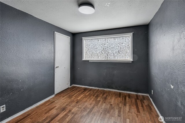 11846 SE 170th Pl, Renton, WA 98258 - spare room featuring wood finished floors and a textured ceiling