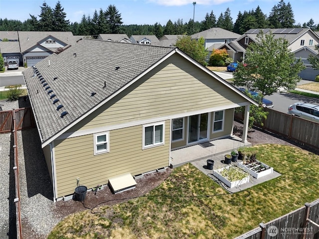 9647 6th Way SE, Lacey, WA 98513 - back of house with a fenced backyard, a residential view, a vegetable garden, and a patio area