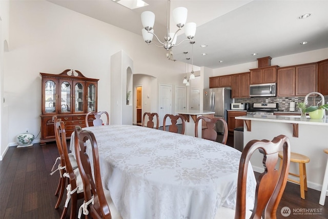 9647 6th Way SE, Lacey, WA 98513 - dining room featuring a chandelier, recessed lighting, arched walkways, and dark wood-type flooring