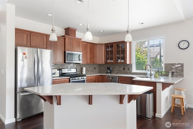 9647 6th Way SE, Lacey, WA 98513 - kitchen with stainless steel appliances, a kitchen bar, decorative backsplash, dark wood finished floors, and recessed lighting