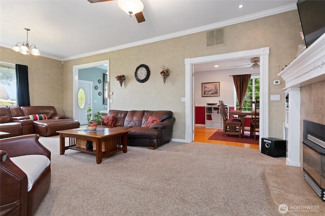 302 S Washington, Everson, WA 98247 - living room featuring ceiling fan, a tiled fireplace, carpet, a chandelier, and crown molding