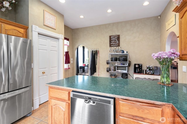 302 S Washington, Everson, WA 98247 - kitchen with appliances with stainless steel finishes, light tile patterned flooring, recessed lighting, a peninsula, and arched walkways