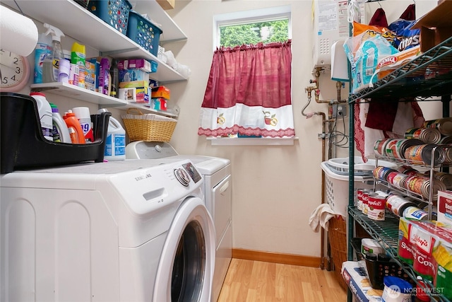302 S Washington, Everson, WA 98247 - laundry room featuring washing machine and clothes dryer, light wood finished floors, and water heater