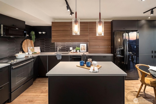 505 Belmont Ave E Unit 801, Seattle, WA 98102 - kitchen with black appliances, rail lighting, light countertops, and backsplash