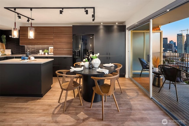 505 Belmont Ave E Unit 801, Seattle, WA 98102 - dining room featuring light wood-style floors, rail lighting, and a skyline view
