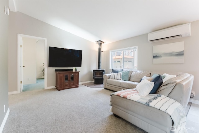 3148 Mountain View Rd, Ferndale, WA 98248 - living room with an AC wall unit, lofted ceiling, a wood stove, and light carpet