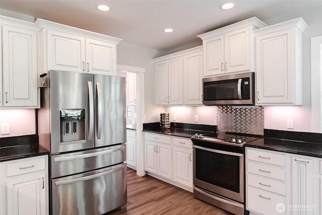 3148 Mountain View Rd, Ferndale, WA 98248 - kitchen with stainless steel appliances, white cabinetry, recessed lighting, and light wood-style floors