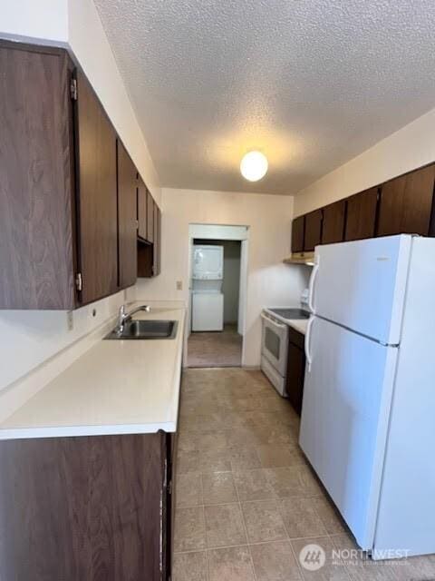 4540 8th Ave NE Unit 903, Seattle, WA 98105 - kitchen featuring white appliances, dark brown cabinetry, light countertops, and a textured ceiling