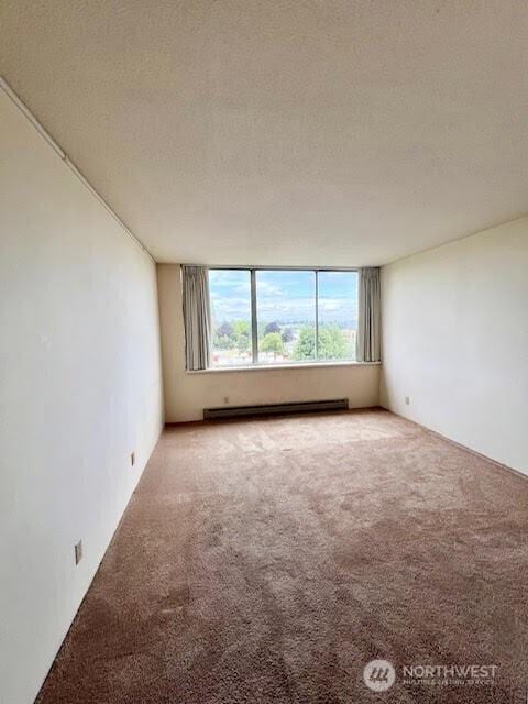 4540 8th Ave NE Unit 903, Seattle, WA 98105 - carpeted spare room with a baseboard radiator
